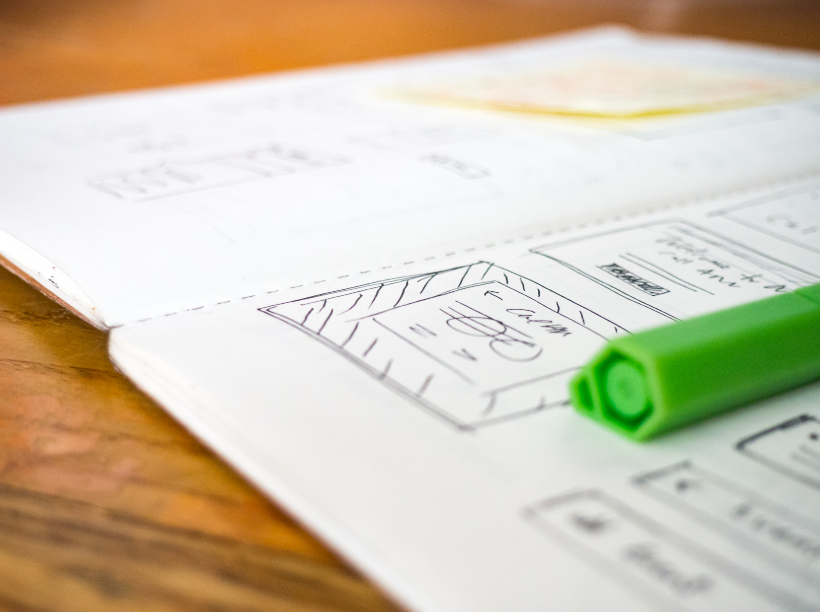 Open Sketchbook on Desk with Green Pen – FOCA