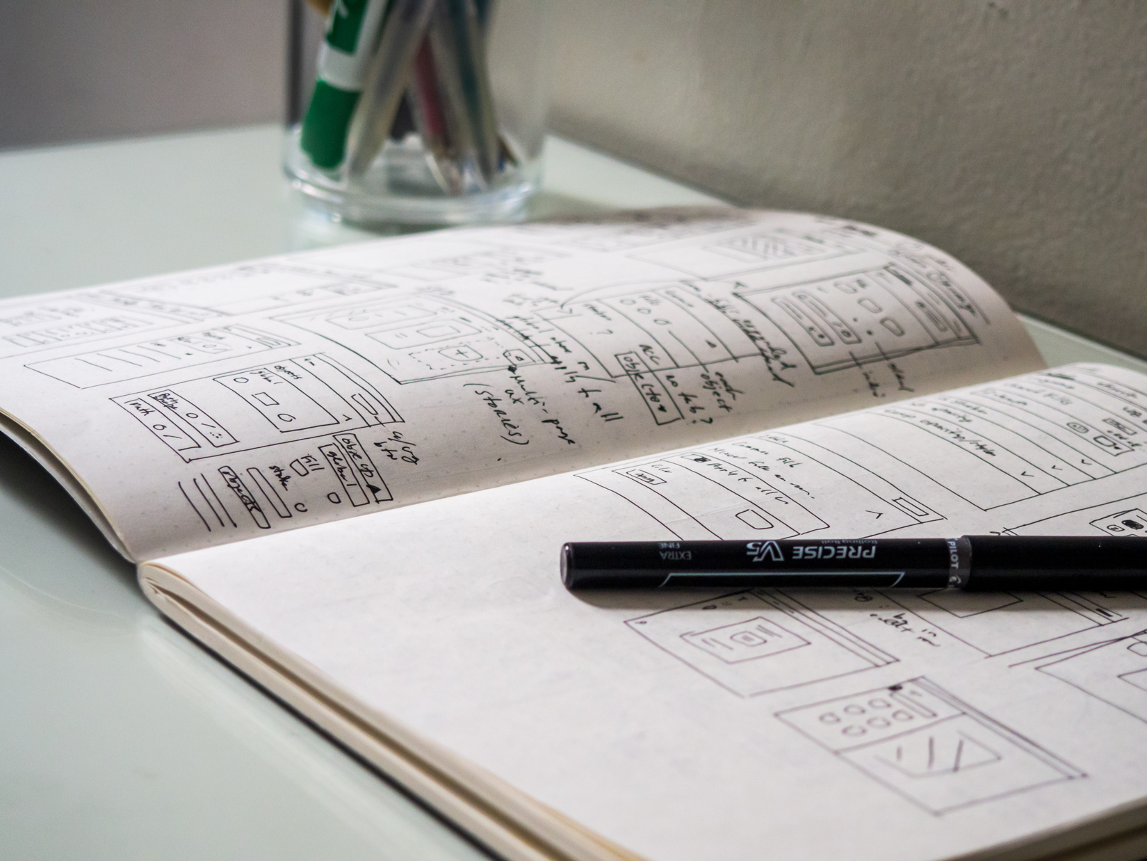 Sketchbook and Pen on Desk