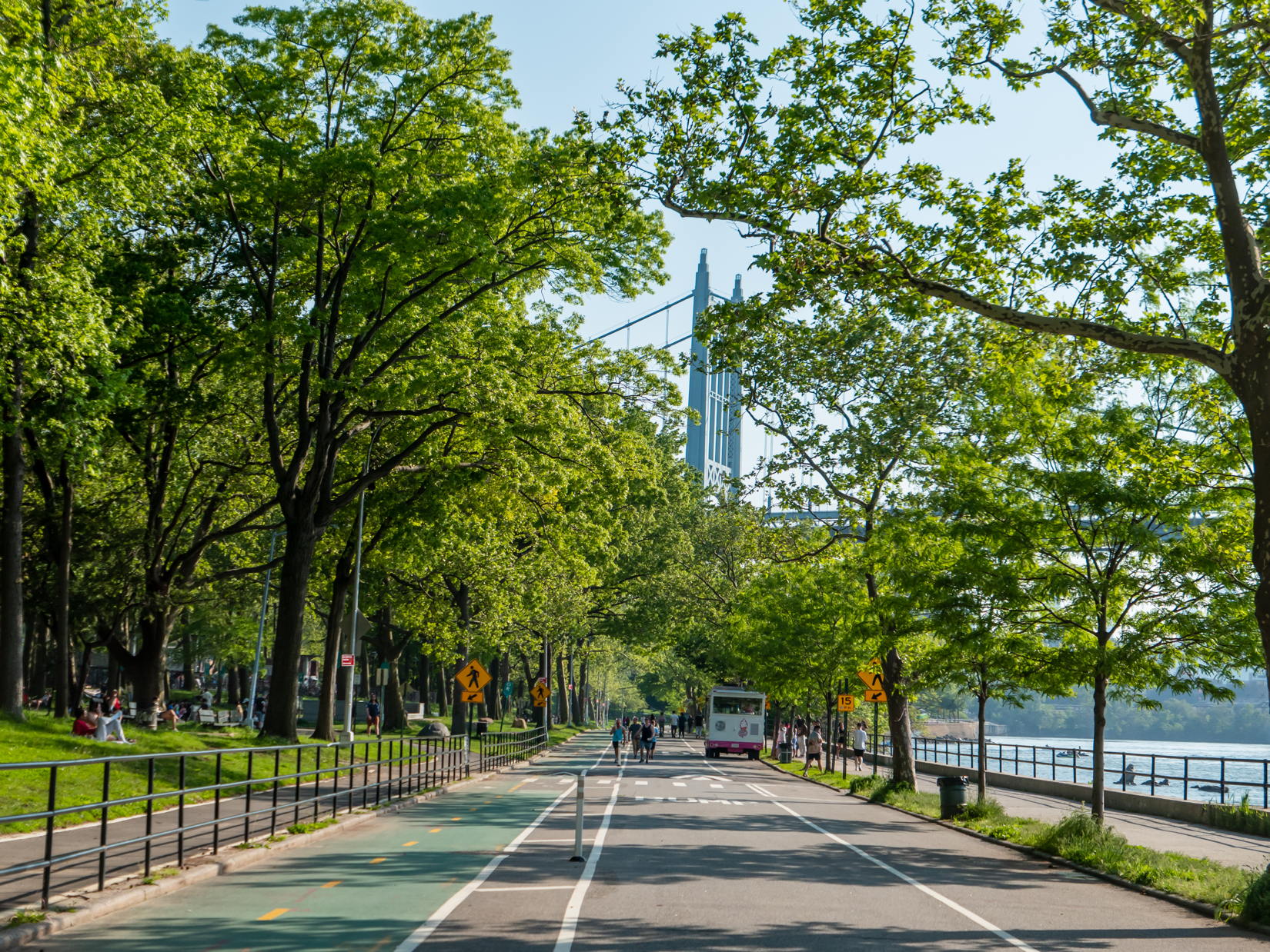 People in Astoria Park with Trees and Bridge
